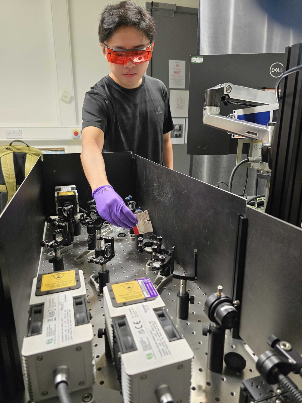Zicheng Cai working at the time-resolved photoluminescence microscopy setup